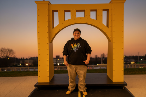 Portrait of tarot reader standing in front of yellow bridge arch with warm golden background